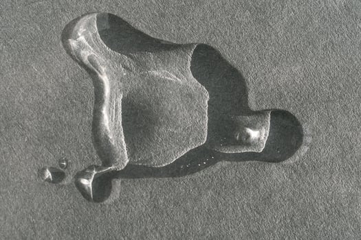 A drop of cosmetic product on a grey background. Texture. photo