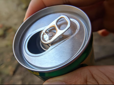 Closeup of male hand holding canned drink photo