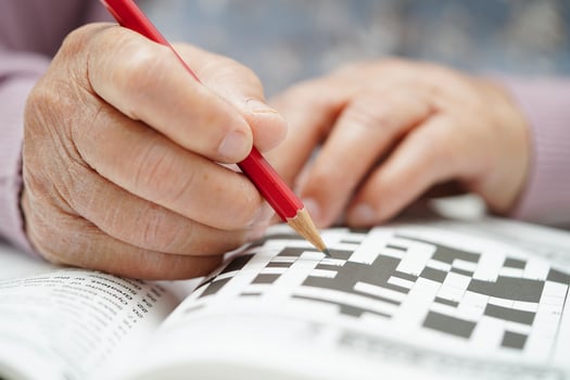 Asian elderly woman playing sudoku puzzle game to practice brain training for dementia prevention, Alzheimer disease. photo