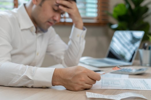 Stressed and headache asian man with large bills or invoices no money to pay to expenses and credit card debt. shortage, Financial problems, mortgage, loan, bankruptcy, bankrupt, poor, empty wallet photo