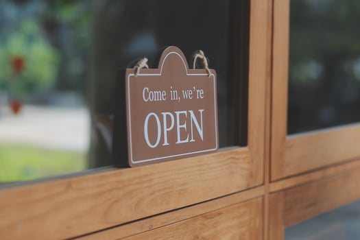 Welcome. Open. barista, waitress woman turning open sign board on glass door in modern cafe coffee shop ready to service, cafe restaurant, retail store, small business owner, food and drink concept photo
