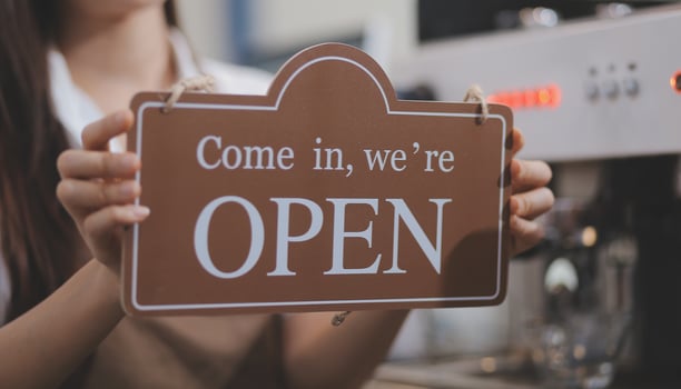 Welcome. Open. barista, waitress woman turning open sign board on glass door in modern cafe coffee shop ready to service, cafe restaurant, retail store, small business owner, food and drink concept photo