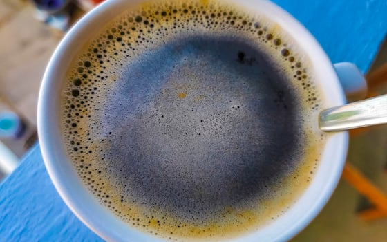 Cup of americano black coffee in tropical restaurant Mexico. photo