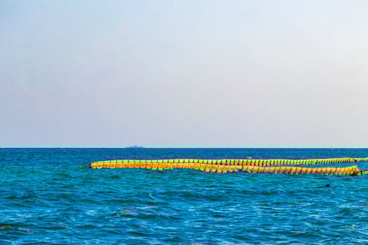 Blue water waves ocean with buoy buoys ropes nets Mexico. photo