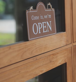 Welcome. Open. barista, waitress woman turning open sign board on glass door in modern cafe coffee shop ready to service, cafe restaurant, retail store, small business owner, food and drink concept photo