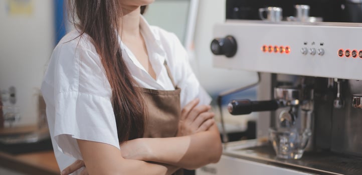 Barista make coffee latte art with espresso machine in cafe vintage color tone photo