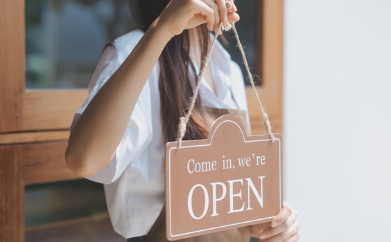Welcome. Open. barista, waitress woman turning open sign board on glass door in modern cafe coffee shop ready to service, cafe restaurant, retail store, small business owner, food and drink concept photo