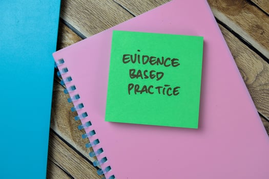 Concept of Evidence Based Practice write on sticky notes isolated on Wooden Table. photo