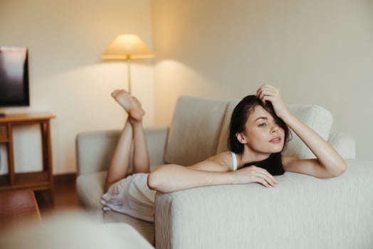 Happy girl smile lying on the couch at home, relaxing at home, comfort, sunshine. photo