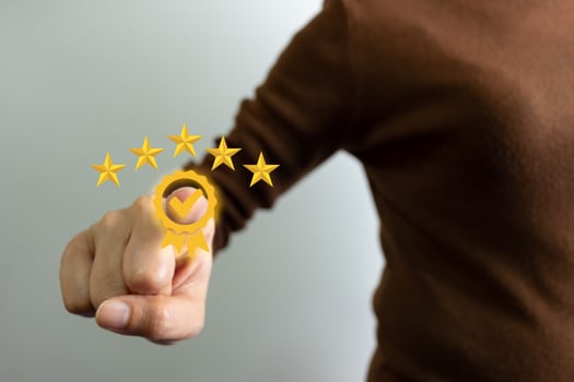 Businesswoman showing the symbol of top service 5 star quality assurance, excellent warranty, world standard, ISO certification, development and improve the quality of the organization concept. photo