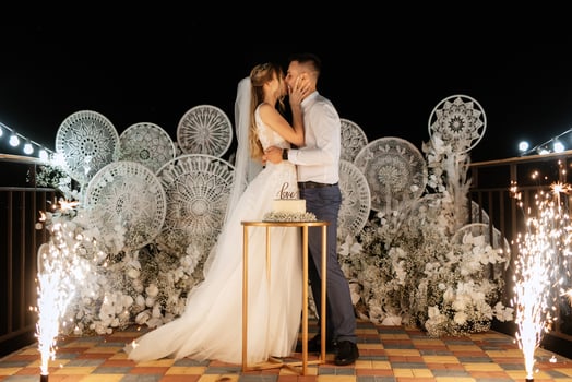 newlyweds happily cut and taste the wedding cake photo