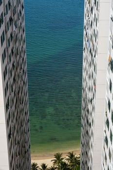 High rise apartment blocks on seashore. Modern multi storey residential buildings on seaside. photo