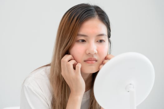 Woman worried about face Dermatology, rosacea dermatitis, allergic steroids, sensitive skin, red face from sunburn, acne, dry skin, large pores ,rash face, dull, freckles, wrinkle, skin problem photo