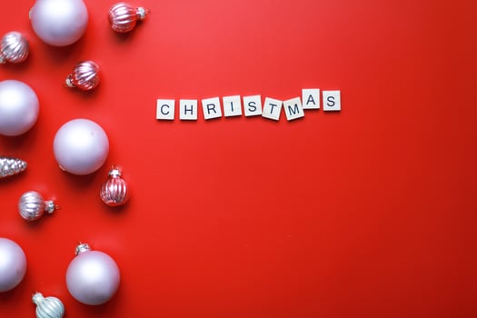 Flat lay inscription Christmas on a red background. Christmas decorations. Christmas card photo