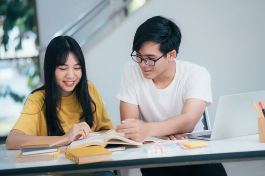 Young students campus helps friend catching up and learning. photo