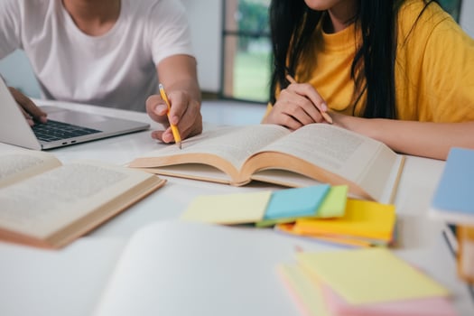 Young students campus helps friend catching up and learning. photo