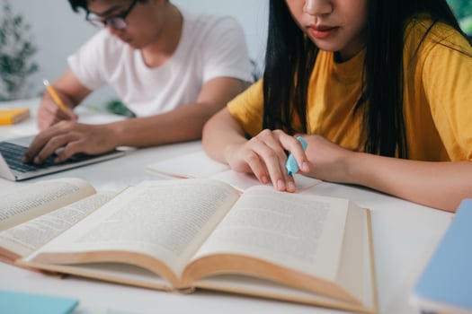 Young students campus helps friend catching up and learning. photo