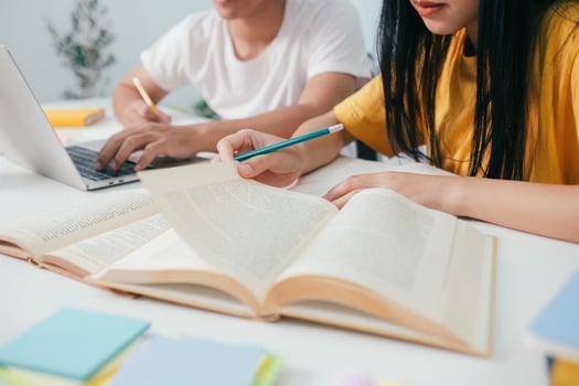Young students campus helps friend catching up and learning. photo
