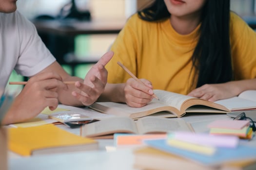 Young students campus helps friend catching up and learning. photo