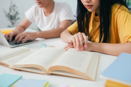 Young students campus helps friend catching up and learning. photo