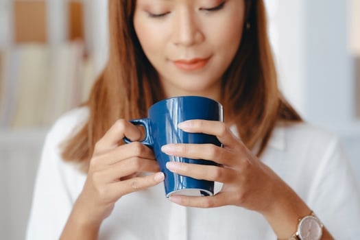 Beautiful woman using laptop at cafe while drinking coffee. photo