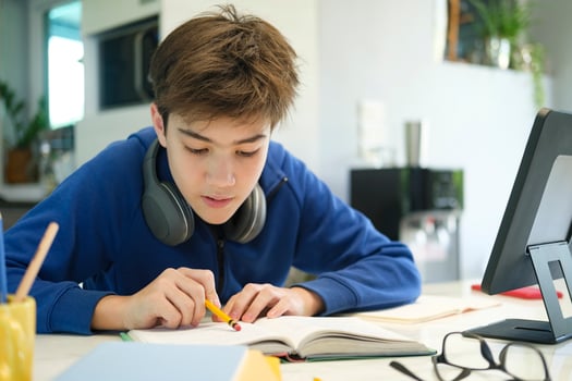 Student boy with tablet computer learning at home photo