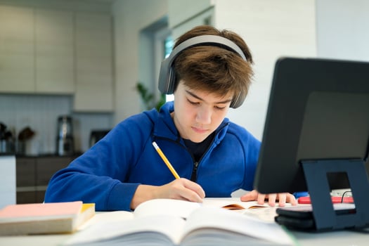 Student boy with tablet computer learning at home photo