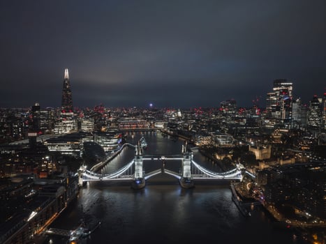 Aerial night view of the lifting up Tower Bridge in London. photo