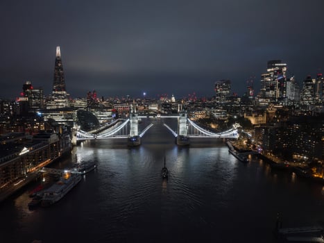 Aerial night view of the lifting up Tower Bridge in London. photo