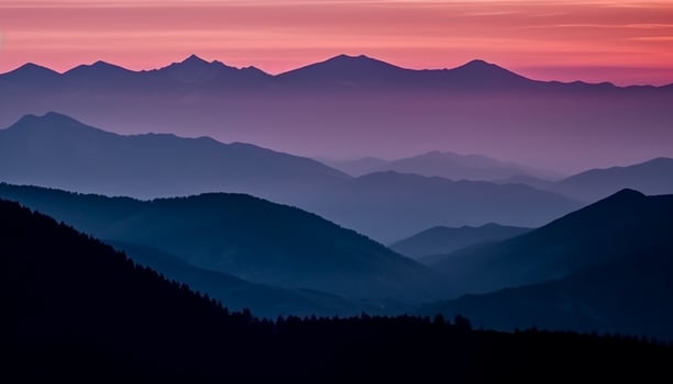 The majestic mountain range silhouetted against the tranquil sunset sky generated by AI photo