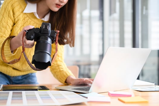 Young photographer checking images from digital camera. photo