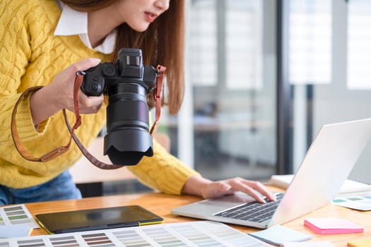 Young photographer checking images from digital camera. photo