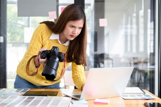 Young photographer checking images from digital camera. photo
