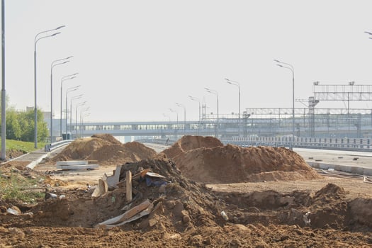 Outdoor construction dirt road earthwork. Repair damage street urban highway photo