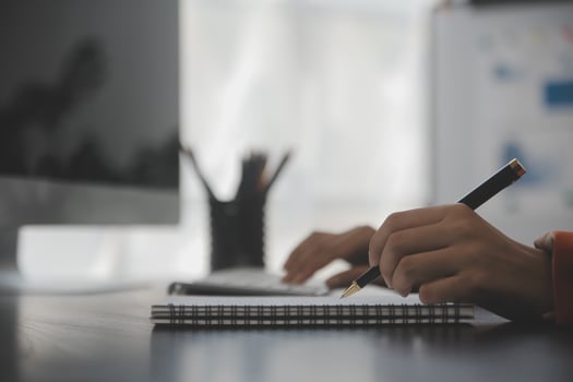 Asian Business woman using calculator and laptop for doing math finance on an office desk, tax, report, accounting, statistics, and analytical research concept photo