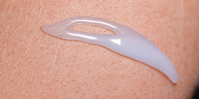 Collagen And Hyaluron Serum Gel On Skin. Splashing of Hyaluron gel. photo