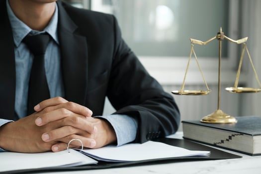 Male lawyer in the office with brass scale. photo