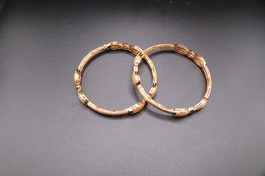 Women gold bangles with black background,bangles design photo