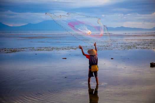 Indonesian Fisherman Throwing a Net photo