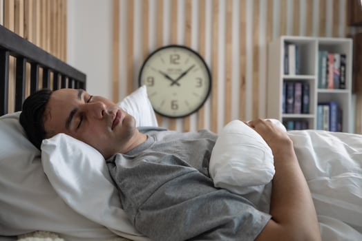 Lazy man oversleep, wake up late, hit the alarm clock frequently with madness. Modern lifestyles often require people to work hard and put in overtime, which can result in not getting enough sleep. photo