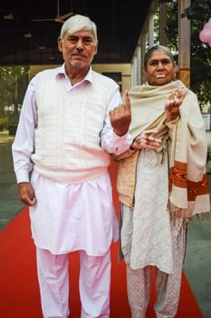 Delhi, India - July 04 2023 - Unidentified people showing their ink-marked fingers after casting votes in front of polling booth of east Delhi area for MCD local body Elections 2022 photo