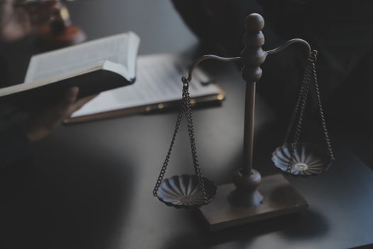 Male lawyer working with contract papers and wooden gavel on tabel in courtroom. justice and law ,attorney, court judge, concept. photo