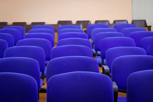 backs of the blue chairs in the auditorium. photo