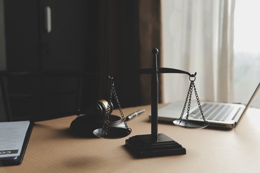 Business and lawyers discussing contract papers with brass scale on desk in office. Law, legal services, advice, justice and law concept picture with film grain effect photo