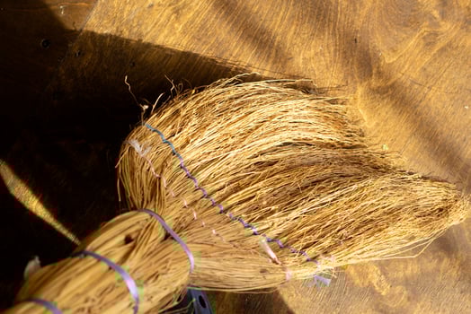 Broom on the background of the plywood floor. photo