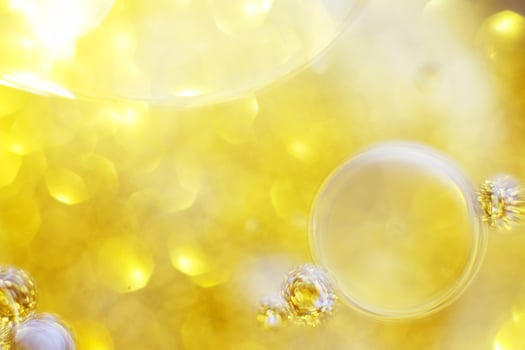 Gold Oil bubbles close up. circles of water macro. abstract shiny yellow background photo