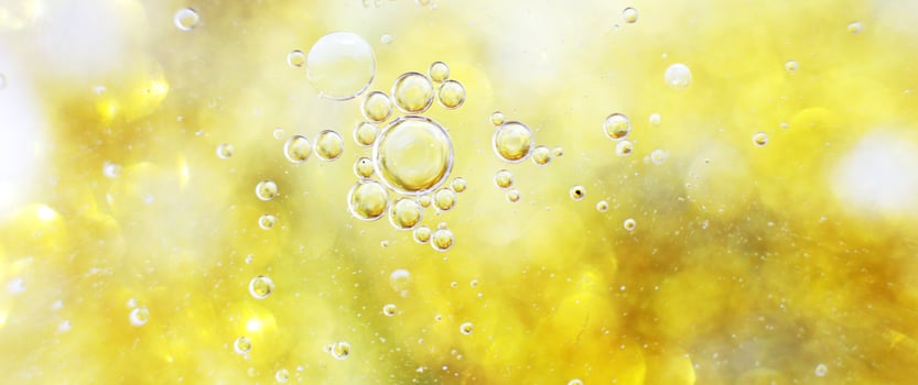 Gold Oil bubbles close up. circles of water macro. abstract shiny yellow background. banner photo
