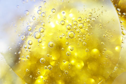 Gold Oil bubbles close up. circles of water macro. abstract shiny yellow background photo