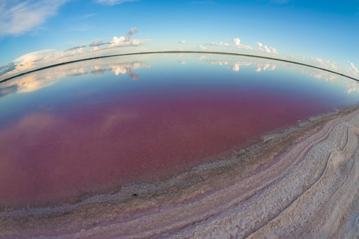 a view of the sky and water from a fish eye lens photo