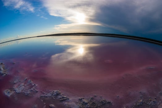 a view of the sky and water from a fish eye lens photo